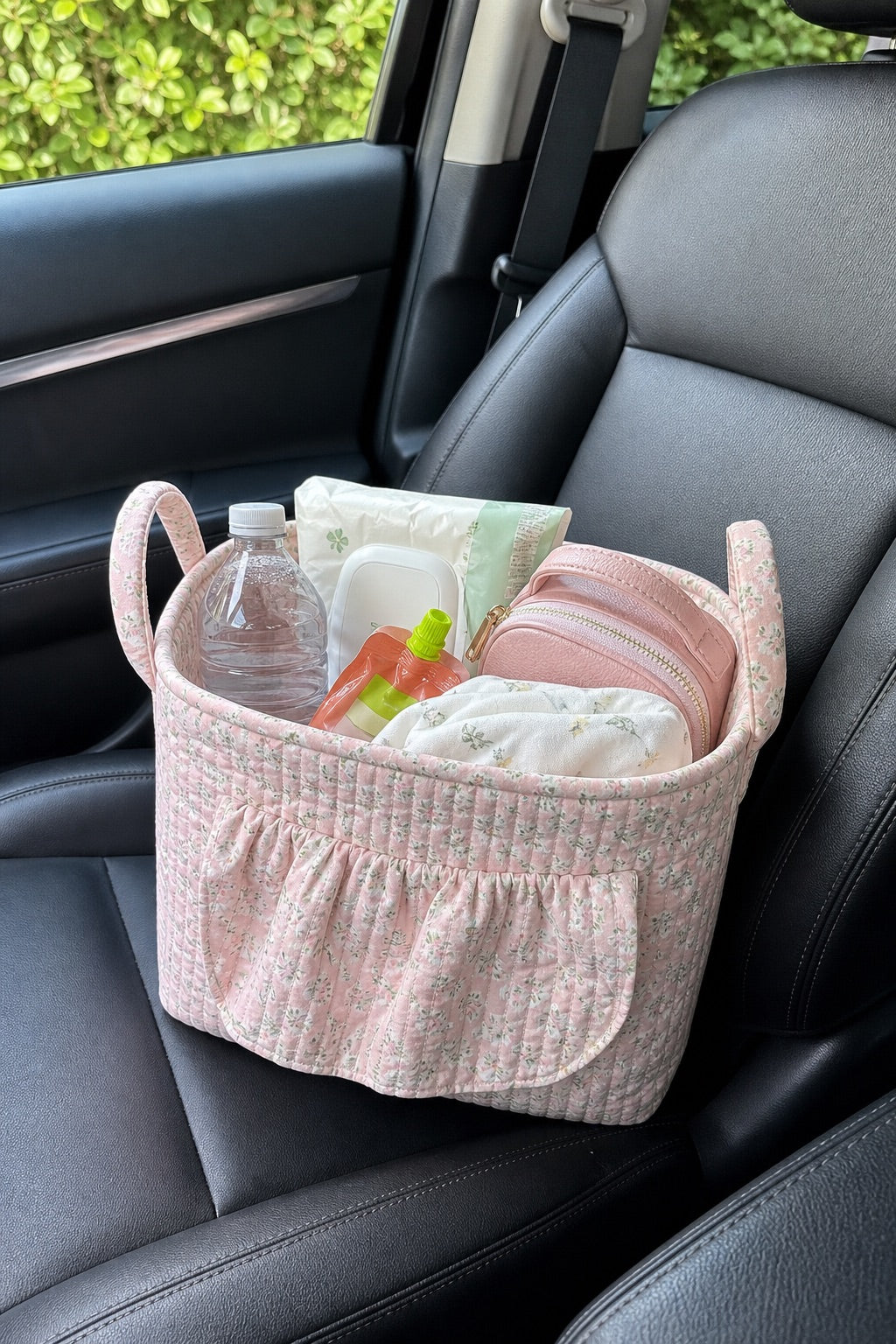 Pink quilted basket holding everyday essentials on a car seat